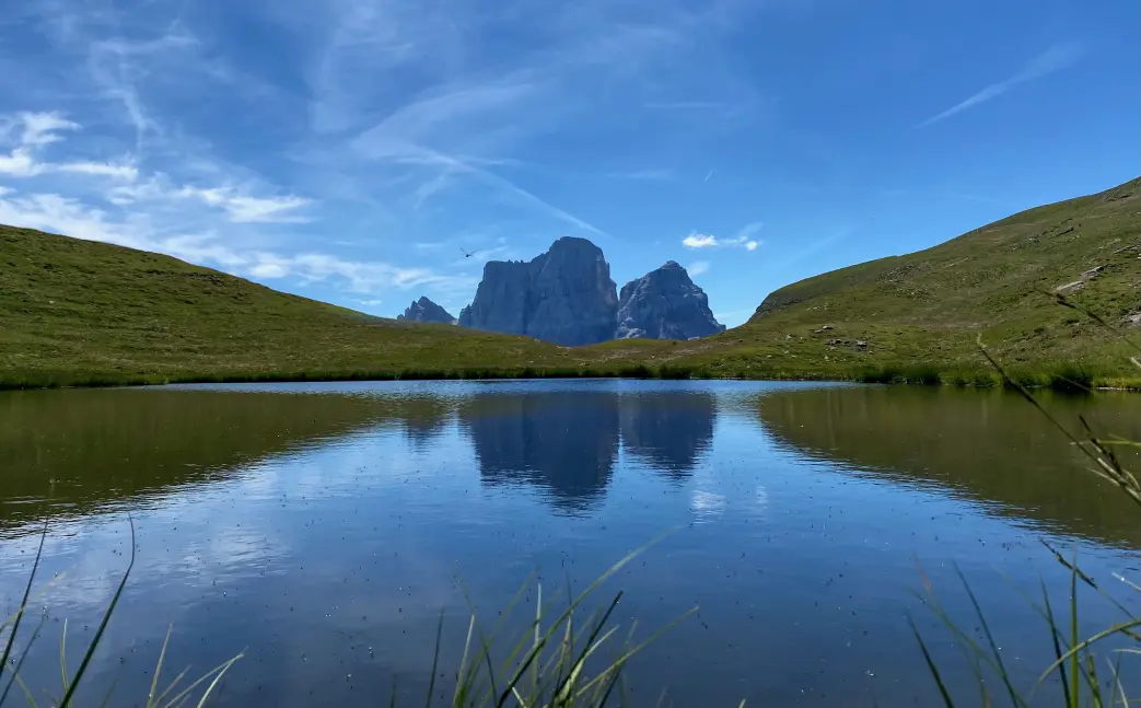 Pelmo's North face reflecting on the surface of the Baste lake