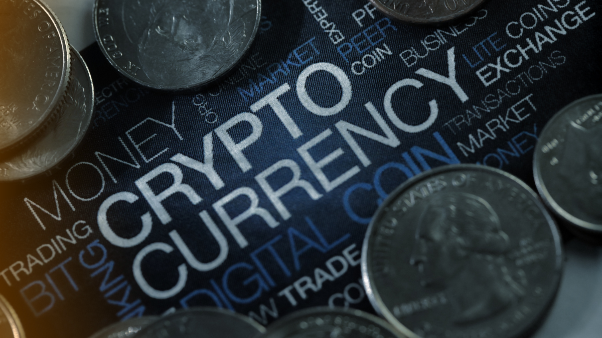 Close-up of coins on a dark background with the word Cryptocurrency highlighted, symbolizing digital money, crypto markets, and blockchain economy.
