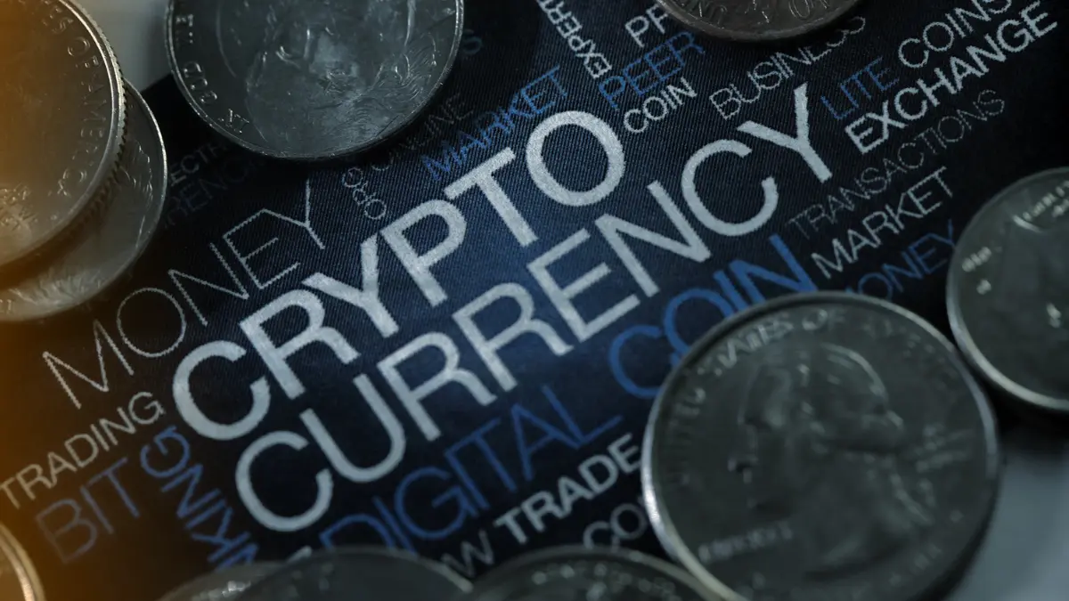 Close-up of coins on a dark background with the word Cryptocurrency highlighted, symbolizing digital money, crypto markets, and blockchain economy.
