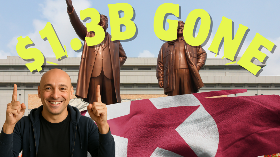NickG smiling and pointing upward under large yellow text reading ‘$1.3B GONE,’ set in front of bronze statues of North Korean leaders and a waving North Korean flag, highlighting a crypto theft story tied to North Korea.