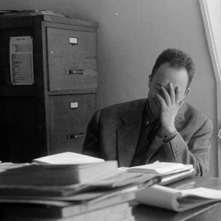 Albert Camus with his hand over his face.
