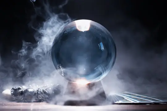 Crystal Ball on a Stand with Smoke Surrounding It.