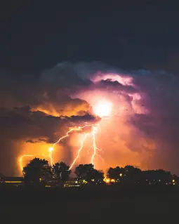Lightening striking trees. Photo by Max LaRochelle on Unsplash
