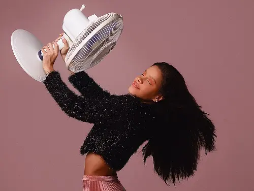 A woman holding a fan