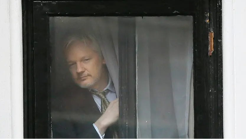 Julian Assange peeking through blinders.