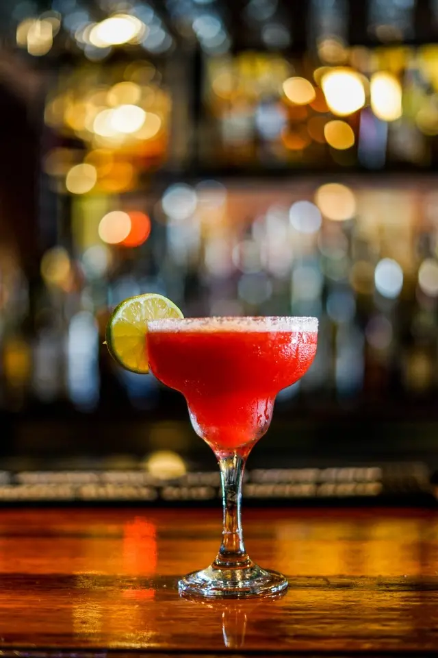 Pink frozen Margarita with lemon garnish