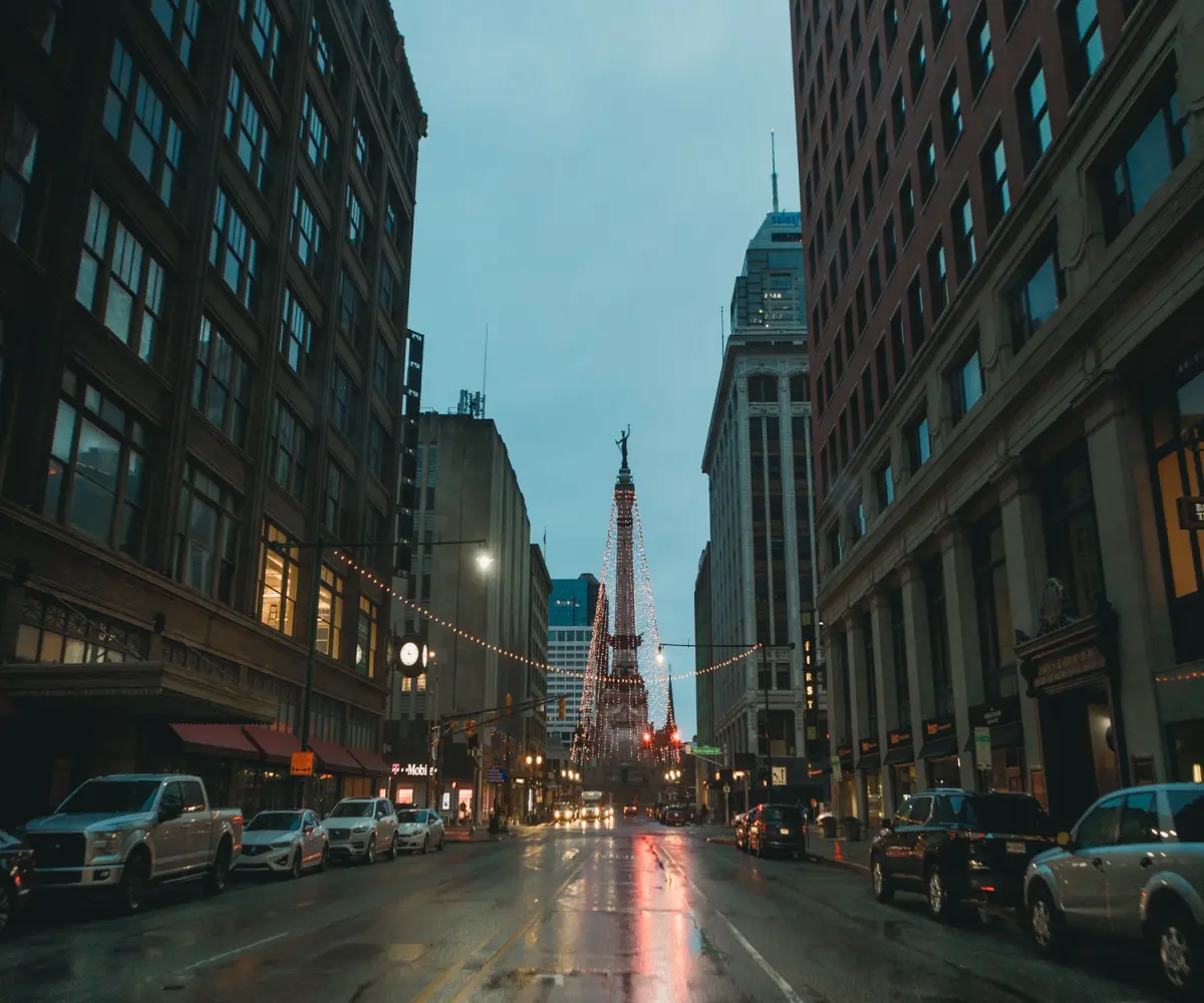 soldiers and sailors monument in downtown indy from a wet street on a rainy day