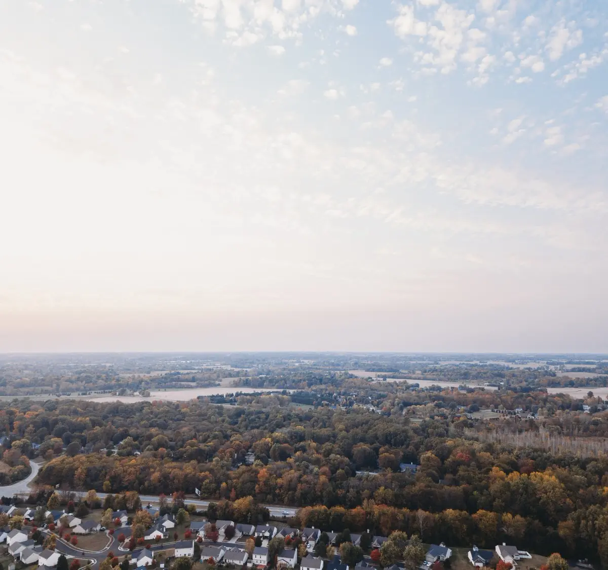 houses and trees at sunset from a drone