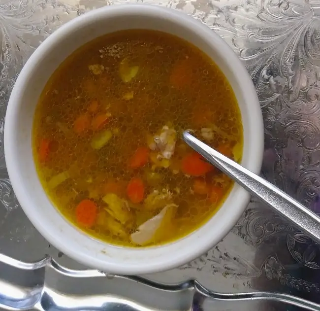 Chicken vegetable soup in white bowl