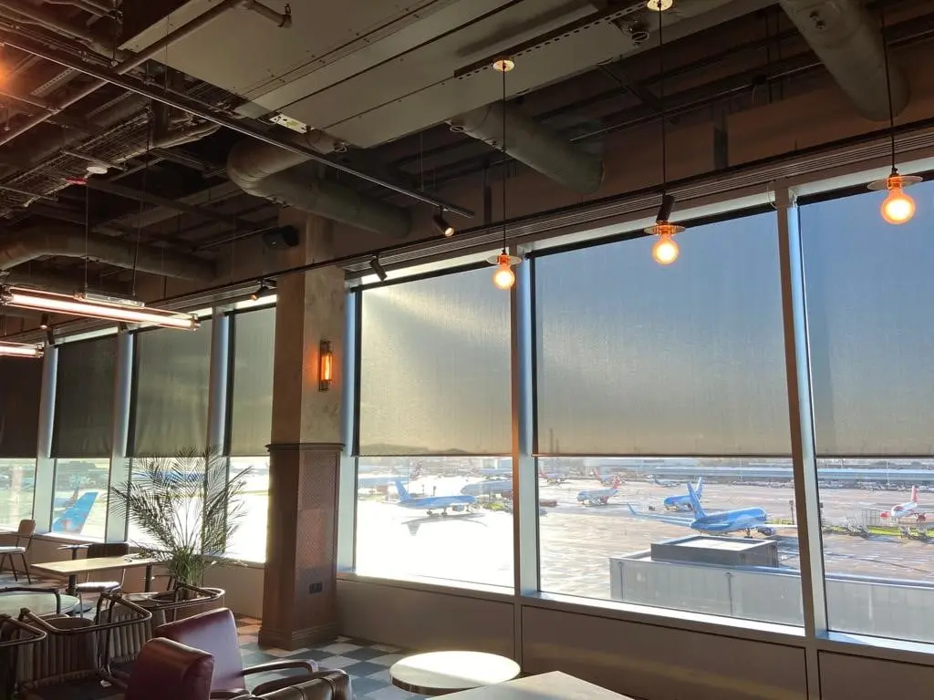 powered roller blinds at half shade on restaurant