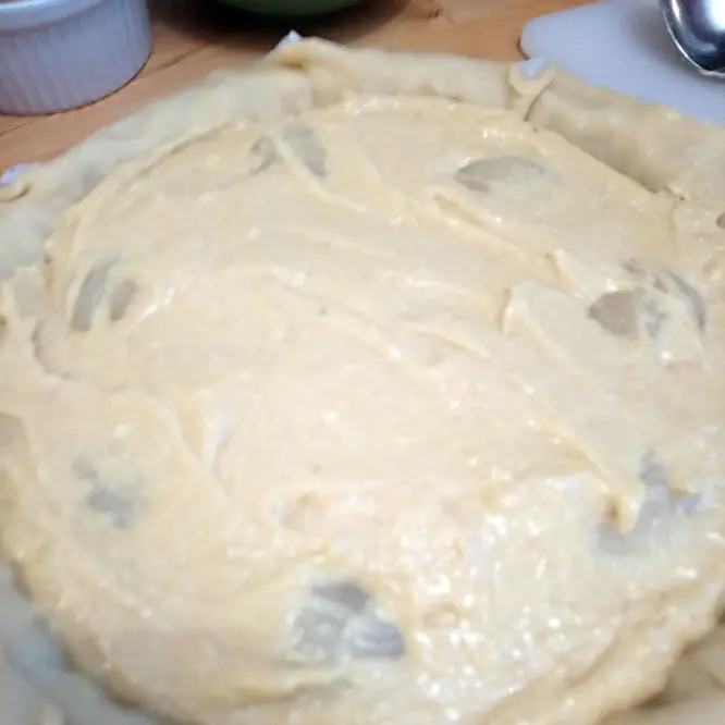 Pour the mix on top of the pear slices, onto the pastry and spread well.