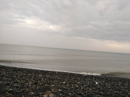 Run at the Beach Under Heavy Rain Next to Restless Waves
