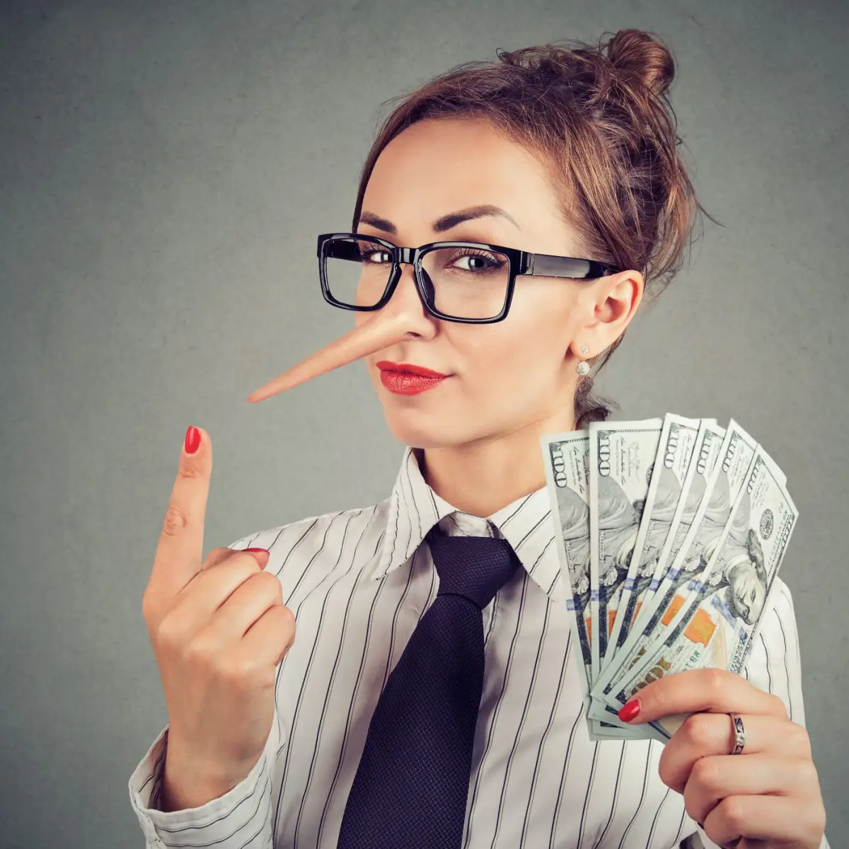 lying business woman holding money with one hand, while pushing in her Pinocchio nose with the other