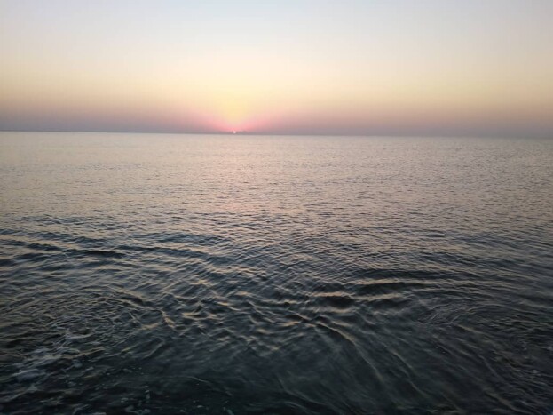 Sunrise, & The Fishing Boat Abandoned among Motionless Waters