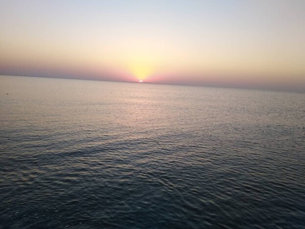 Sunrise, & The Fishing Boat Abandoned among Motionless Waters