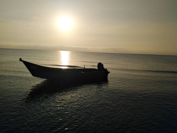 Sunrise, & The Fishing Boat Abandoned among Motionless Waters
