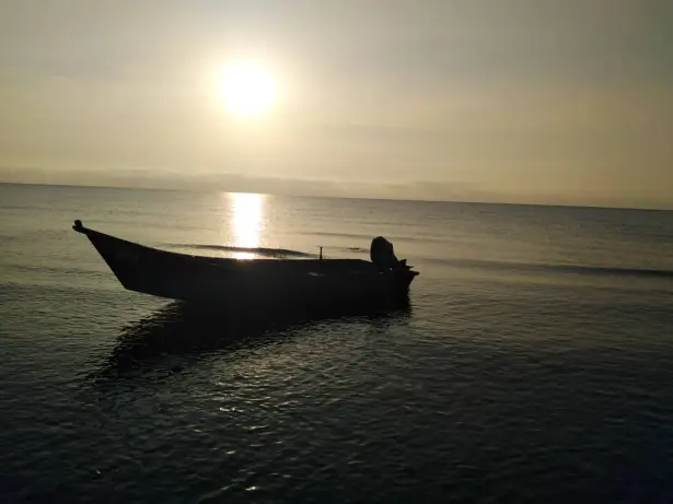 Sunrise, & The Fishing Boat Abandoned among Motionless Waters