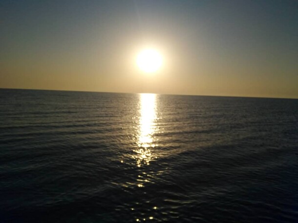 Sunrise, & The Fishing Boat Abandoned among Motionless Waters