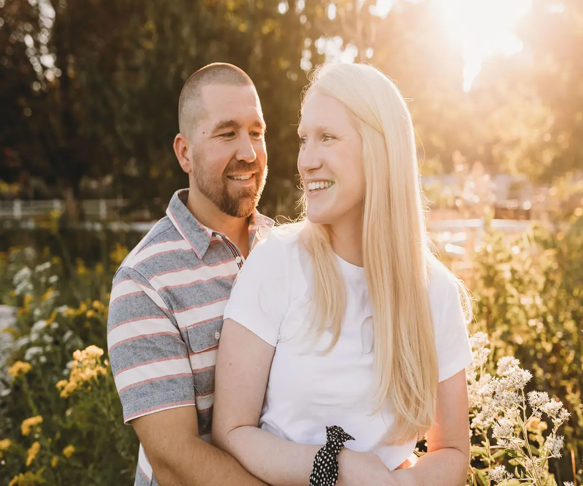 couple in lincoln park with sun setting behind them