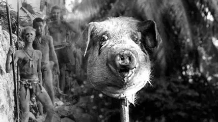 A severed pig's head with little boys behind it