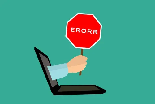 a hand coming out of the screen of a laptop holding an error sign