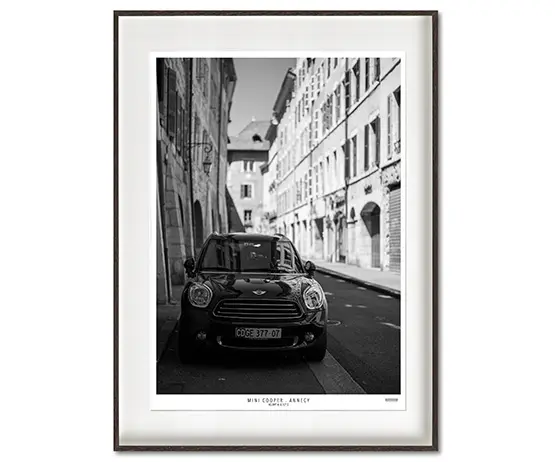 Mini Cooper parked in romantic alley in Annecy - France.
