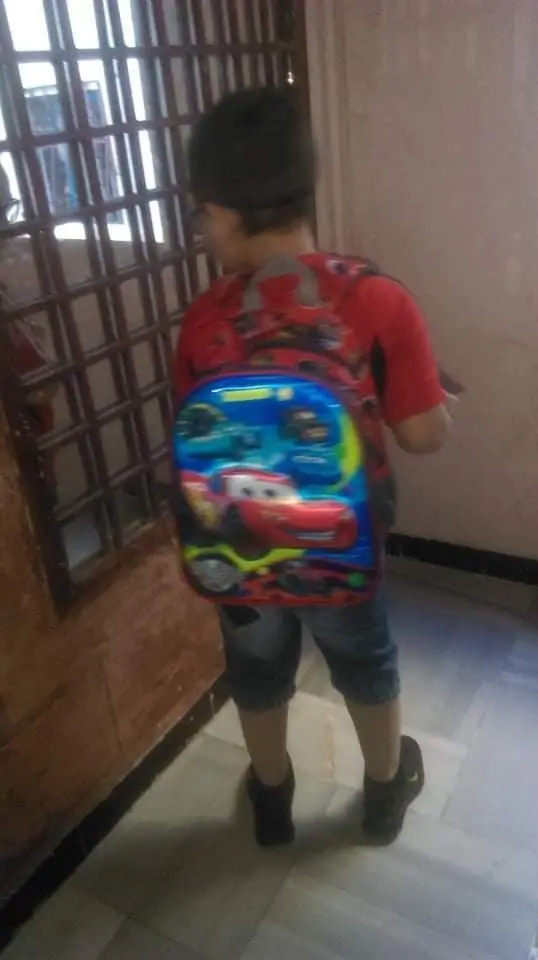The mentally disabled Syrian boy wearing a backpack of the character Lightning McQueen from the hit Pixar film, Cars.