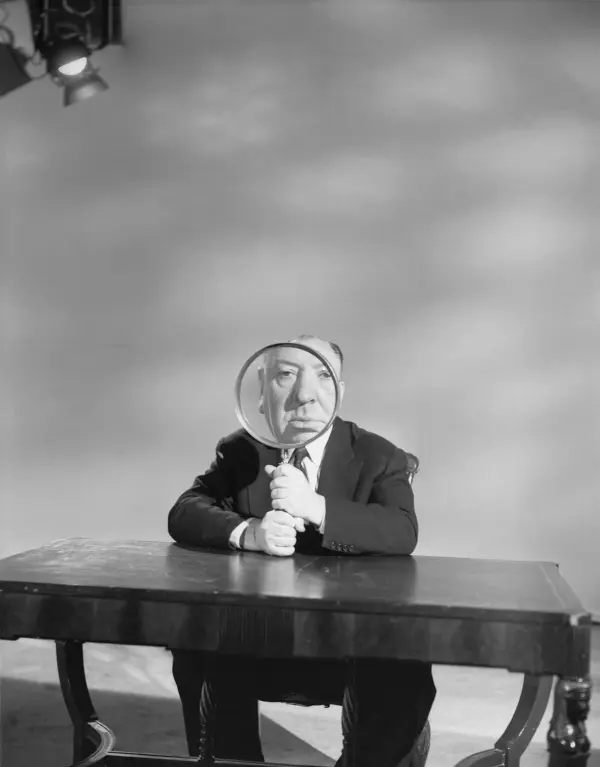 Alfred Hitchcock pictured holding a magnifying glass