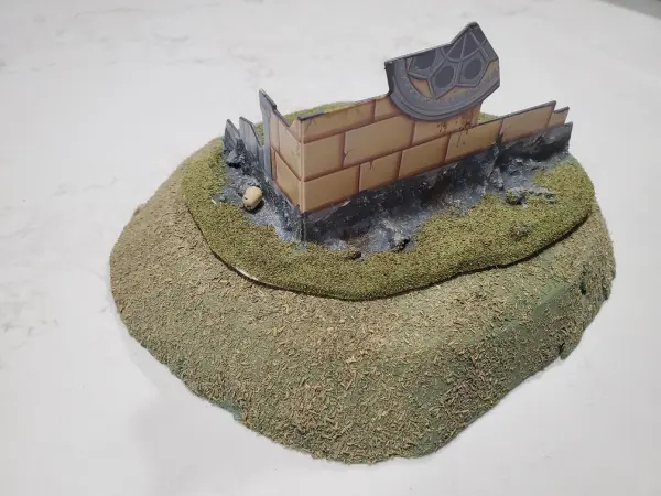 The same small hill as above but combined with fortifications of a Gothic style (WH40K)