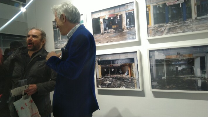 Artist in blue blazer on opening night of exhibition