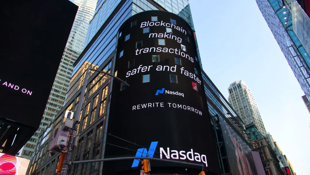 NASDAQ billboard in Times Square, says “Blockchain making transactions safer and faster”