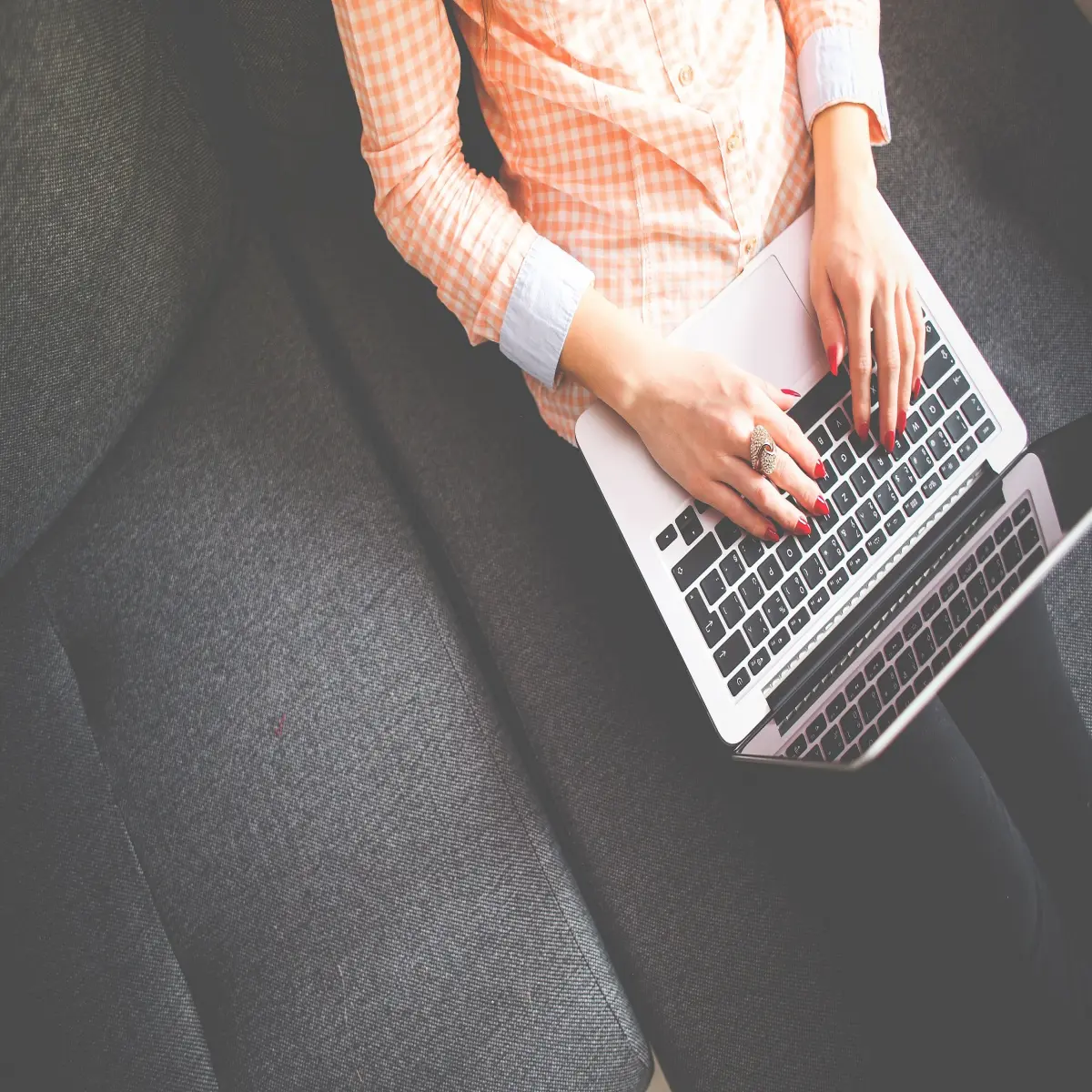 A woman blogger typing on a laptop