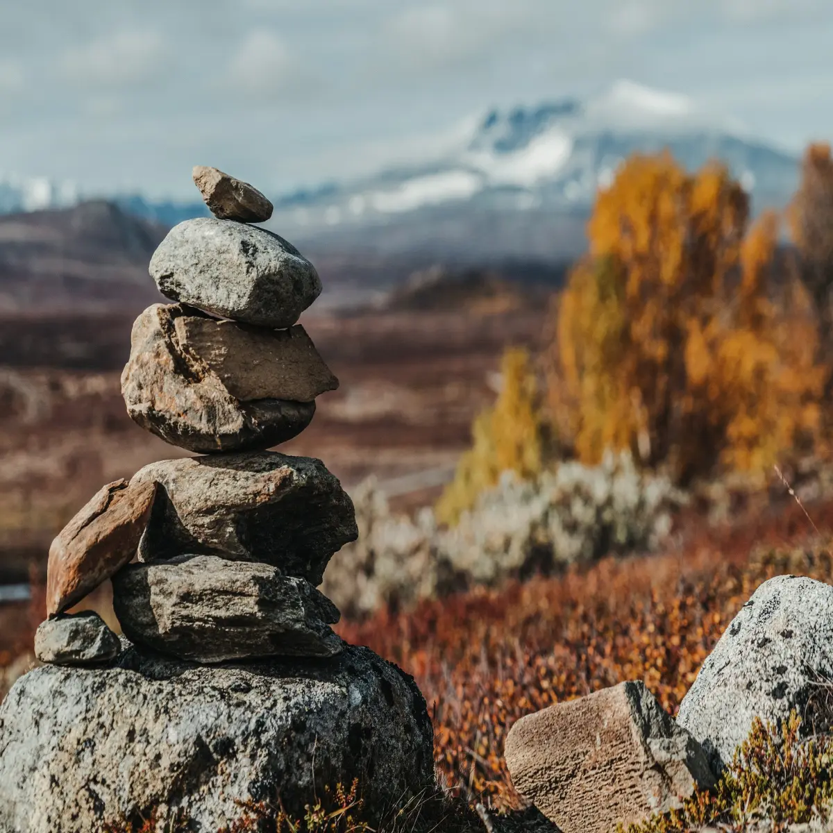 A stack of rocks with a mountain in the background