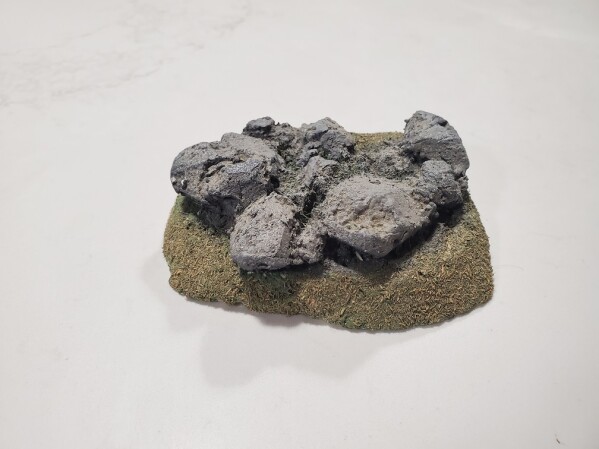 Small rock outcropping on a grass flock base for war gaming scenery