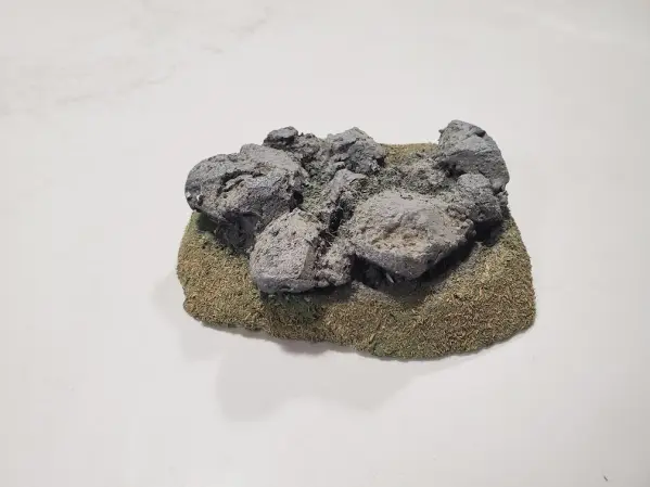 Small rock outcropping on a grass flock base for war gaming scenery