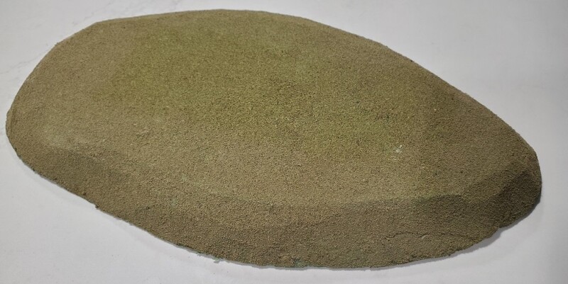 A large hill covered with grass flock for tabletop gaming