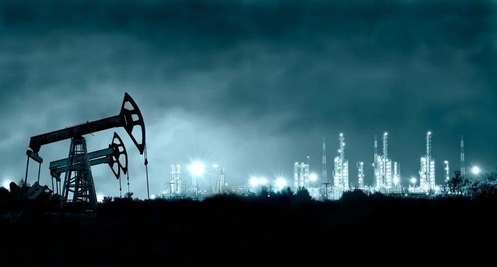 Oil Pump And Refinery At Night
