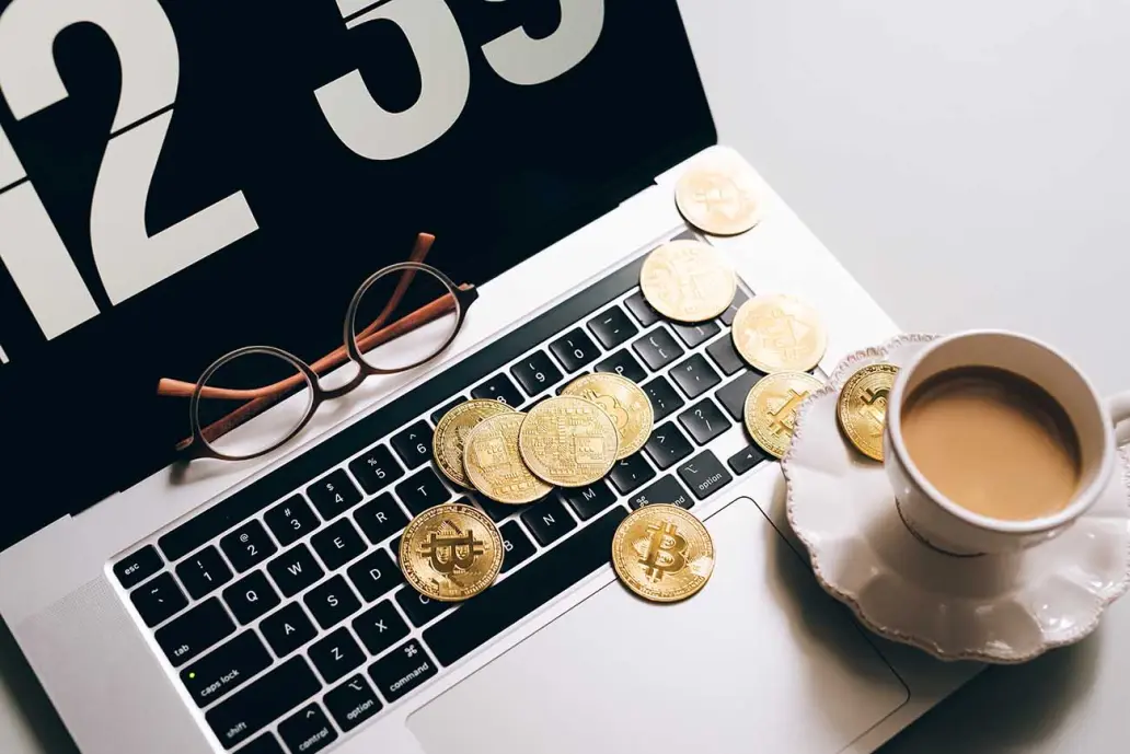 crypto coins on laptop - nicoleharbnft