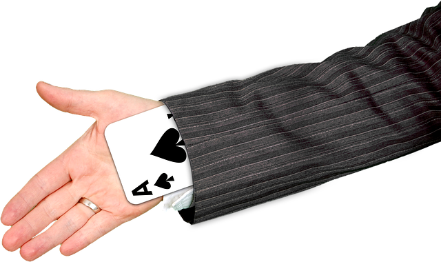 A playing card in a hand.