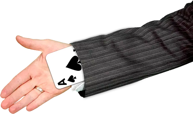 A playing card in a hand.