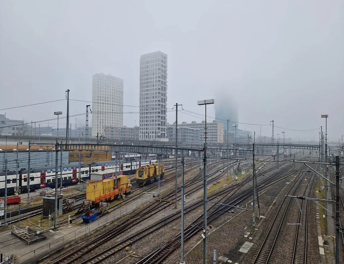 gray day walking over a bridge that crosses over the train tracks
