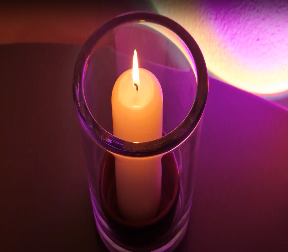 Candle with purple light background