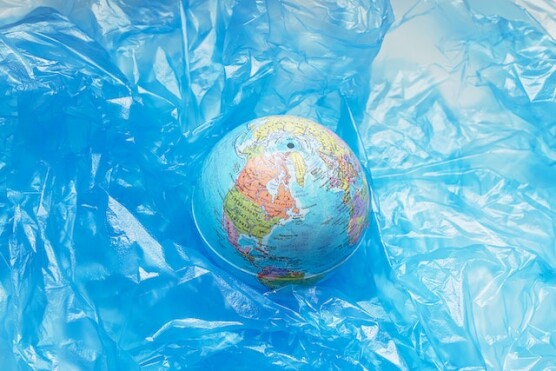 a globe surrounded by plastic material